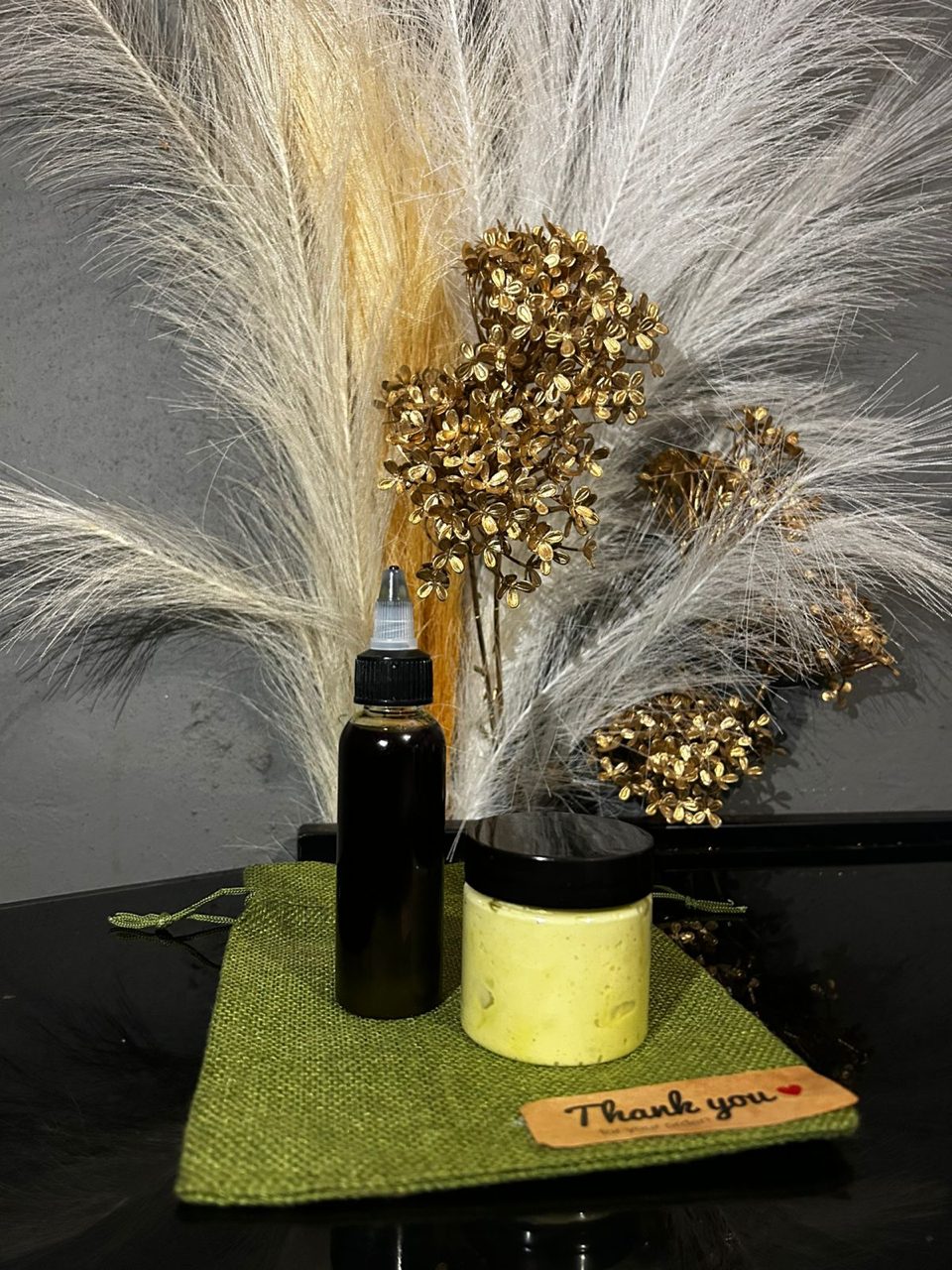Actual WM&R Naturals oil bottle and cream jar displayed together